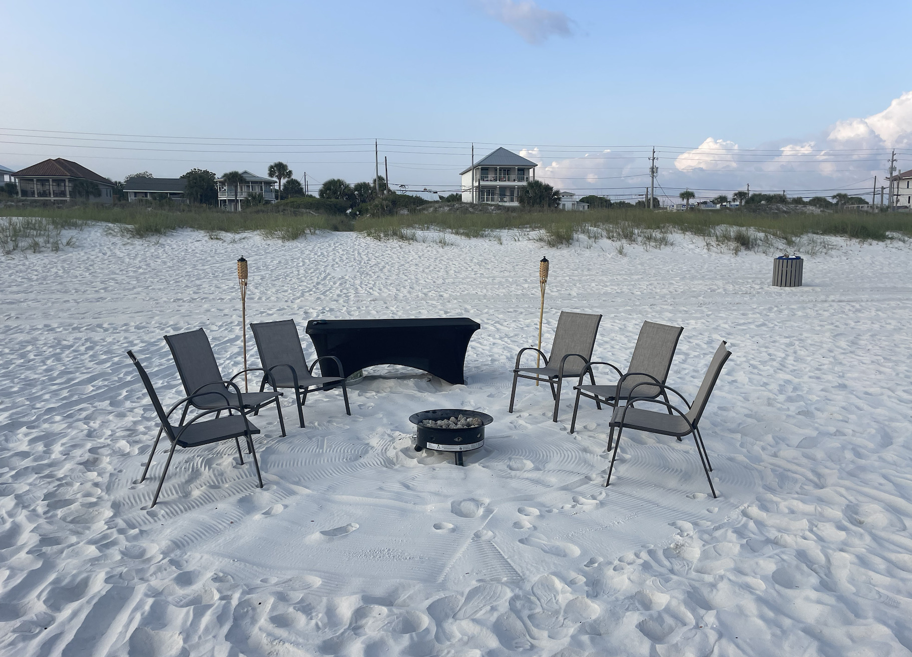 Beach bonfire setup with chairs and fire pit